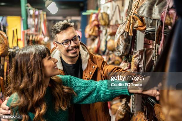 young couple shopping in a thrift store - buenos aires travel stock pictures, royalty-free photos & images