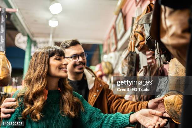 young couple shopping in a thrift store - couple antique shopping stock pictures, royalty-free photos & images