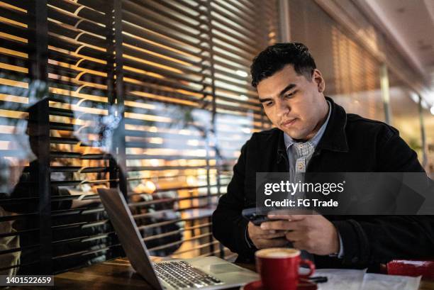 businessman working using smartphone in a restaurant - answering email stock pictures, royalty-free photos & images