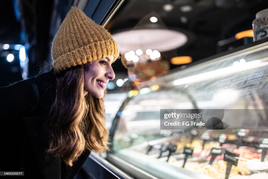 Young woman looking at ice cream counter