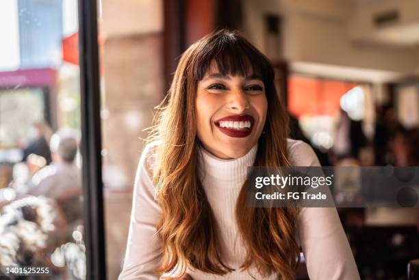 young woman in a cafeteria - brown hair stock pictures, royalty-free photos & images