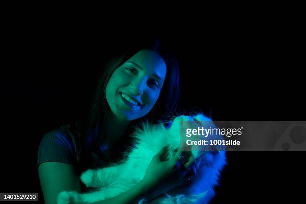 woman with green and dark blue gel lighting. - black cat green eyes stock pictures, royalty-free photos & images