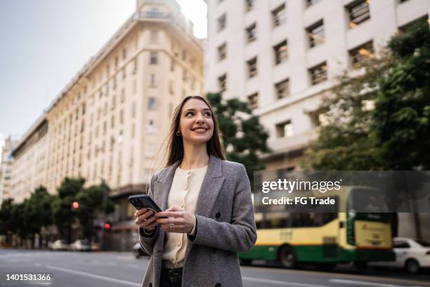 besinnliche junge frau auf der straße - buenos aires people stock-fotos und bilder