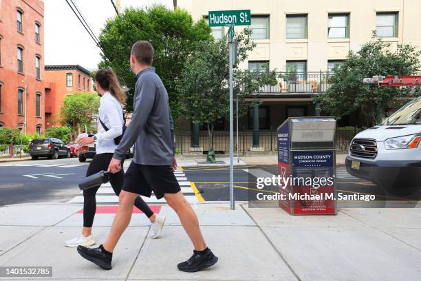 People walk past an election drop box during Midterm Primary Election Day on Hudson and Sixth Street on June 07, 2022 in Hoboken, New Jersey. New...