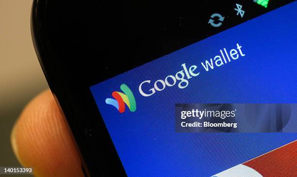 The Google Inc. Mobile Wallet application for cardless payment is displayed on a smartphone screen at the Mobile World Congress in Barcelona, Spain,...