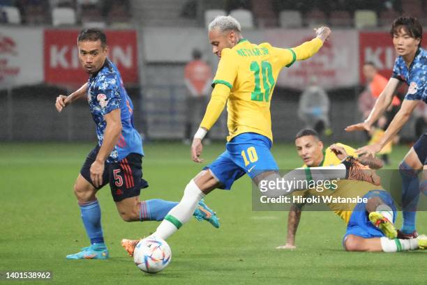Yuto Nagatomo of Japan and Neymar Jr of Brazil compete for the ball during the international friendly match between Japan and Brazil at National...