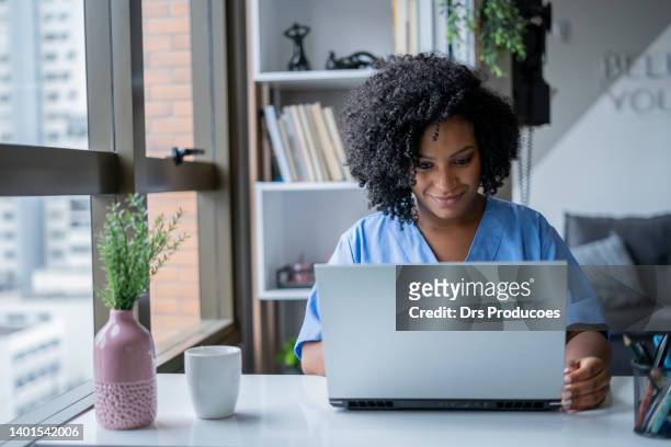 nurse in consultation by video call - remote location stock pictures, royalty-free photos & images