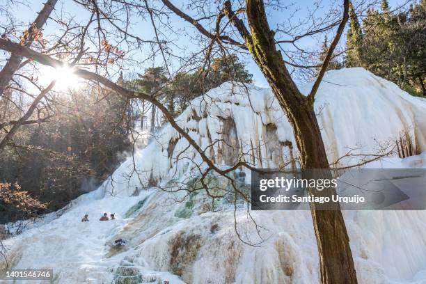 tourists taking a bath in bagni san filippo - calcification stock pictures, royalty-free photos & images