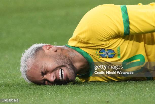 Neymar Jr of Brazil reacts after suffering an injury during the international friendly match between Japan and Brazil at National Stadium on June 06,...