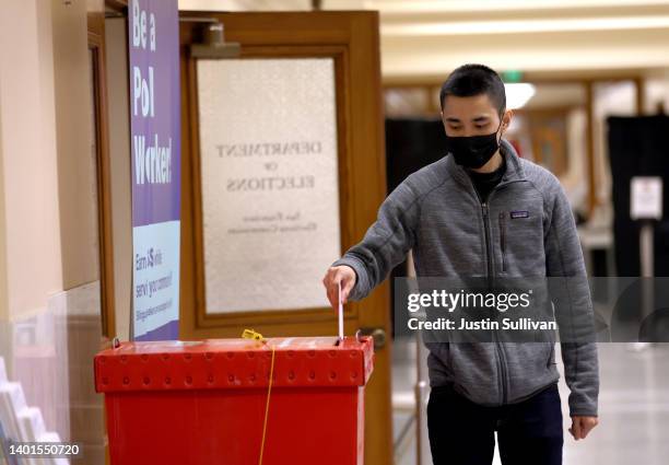 Voter drops his ballot into a box in a polling station at San Francisco City Hall on June 07, 2022 in San Francisco. California. California voters...