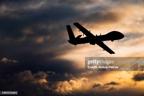 military  unmanned aerial vehicle at sunset. combat drone in military conflicts - military intelligence stock pictures, royalty-free photos & images