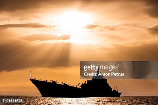 Warship at sunset in the sea. Fleet flagship