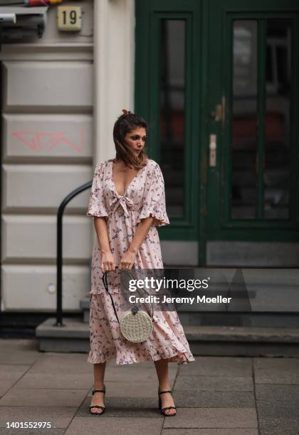 Anna Wolfers seen wearing light pink maxi dress with floral print, a round bast bag and black leather heels on June 02, 2022 in Hamburg, Germany.