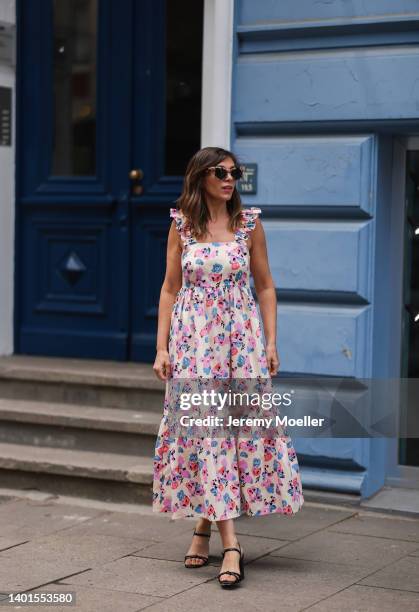 Anna Wolfers seen wearing a brown sunglasses, a white maxi dress with pink/blue floral print and black heels on June 02, 2022 in Hamburg, Germany.