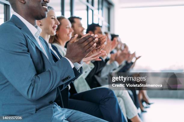 businesspeople applauding during a seminar in conference hall. - congratulations stock pictures, royalty-free photos & images