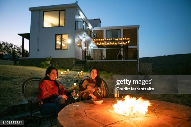 female friends by fire pit - fire pit stock pictures, royalty-free photos & images