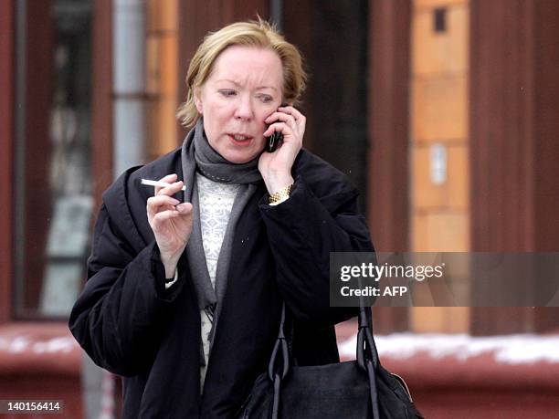 The European Union's ambassador to Belarus Maira Mora speaks by cell phone as she leaves the French embassy in Minsk, on February 29 after her...