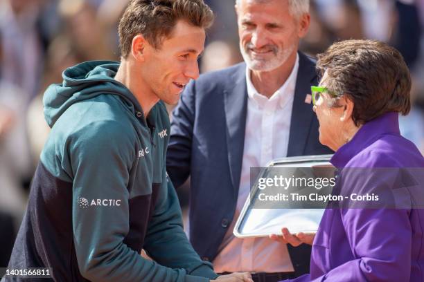 Casper Rudd of Norway receives his runners up trophy from Billie Jean King watched by French Tennis Federation President Gilles Moretton after his...