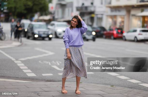 Anna Wolfers seen wearing a purple knit sweater, a light blue midi dress with floral print and light orange heels on June 02, 2022 in Hamburg,...