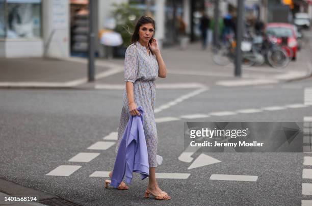Anna Wolfers seen wearing a purple knit sweater, a light blue midi dress with floral print and light orange heels on June 02, 2022 in Hamburg,...