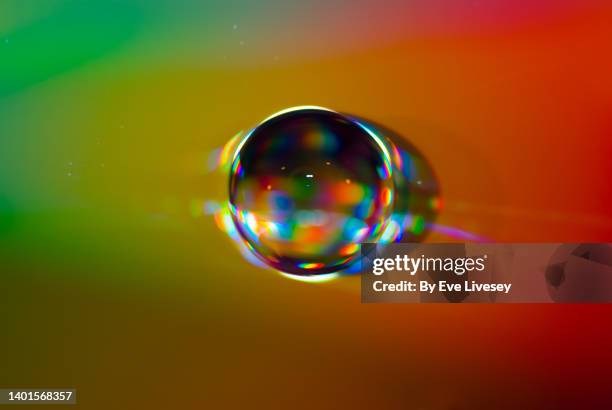 drop of water on a compact disc - colorful cd photos et images de collection