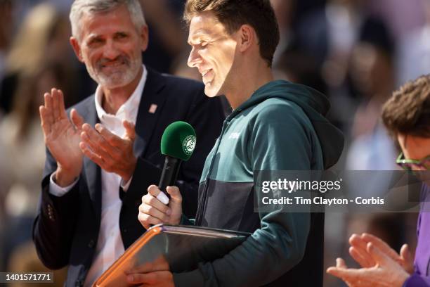 Casper Rudd of Norway makes a speech after receiving his runners up trophy from Billie Jean King watched by French Tennis Federation President Gilles...