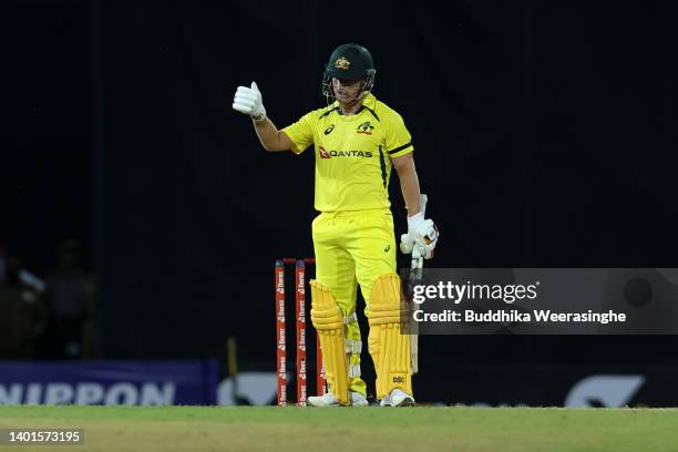 Australian batsman David Warner celebrates his fifty runs during the 1st match in the T20 International series between Sri Lanka and Australia at R....