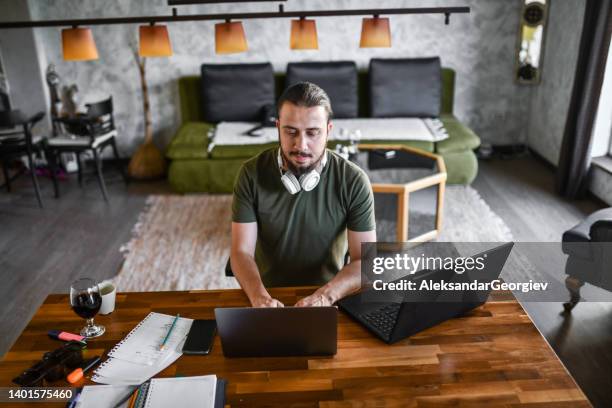 male magazine editor completing new edition while working from home - article stock pictures, royalty-free photos & images