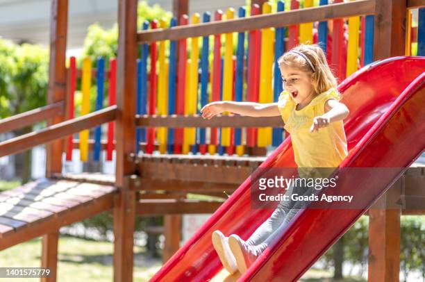 excited girl sliding down the toboggan - sliding stock pictures, royalty-free photos & images