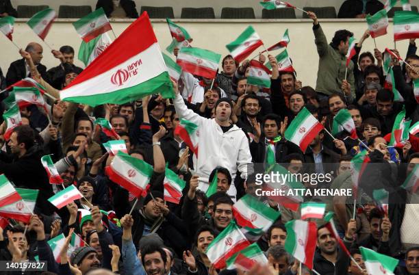 Iranian football fans cheer for their team during their 2014 World Cup Asian zone group E qualifying football match against Qatar at the Azadi...