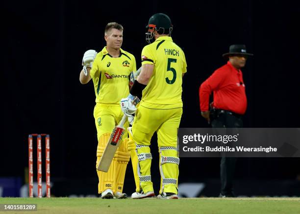 Australian batsman Aaron Finch celebrates, left, and David Warner celebrate after winning the match during the 1st match in the T20 International...