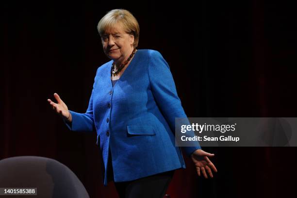 Former German Chancellor Angela Merkel arrives for a conversation with journalist Alexander Osang on stage at the Berliner Ensemble theatre on June...