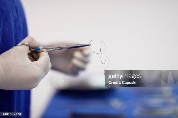 professional getting suture for a surgical procedure - hecht stockfoto's en -beelden