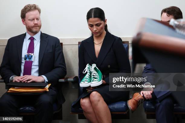 Camila Alves McConaughey, wife of actor Matthew McConaughey, holds a pair of shoes worn by one of the victims of the school shooting in Uvalde,...