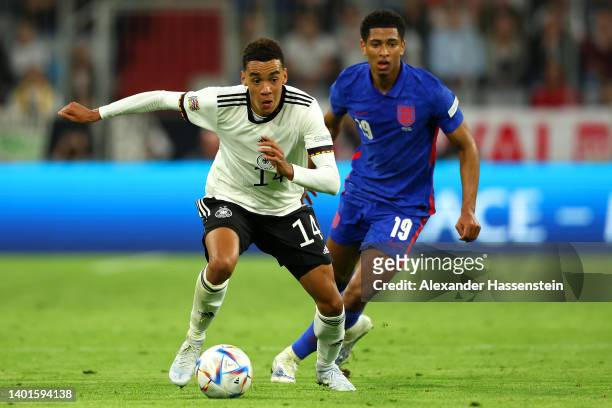 Jamal Musaiala of Germany is challenged by Jude Bellingham of England during the UEFA Nations League League A Group 3 match between Germany and...