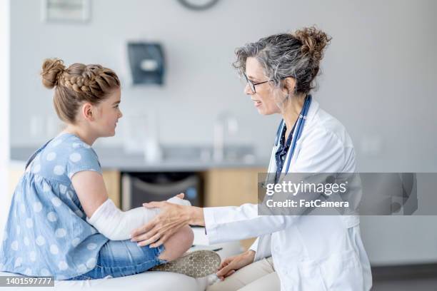 broken arm check-up - child having medical bones stock pictures, royalty-free photos & images