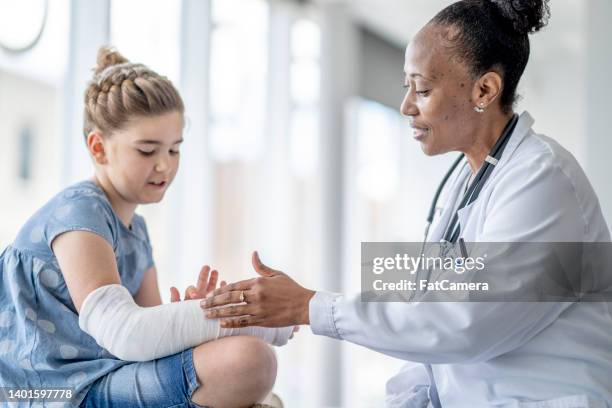 broken arm check-up - child having medical bones stock pictures, royalty-free photos & images