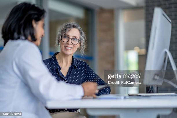 patient at a doctors appointment - medical insurance stock pictures, royalty-free photos & images