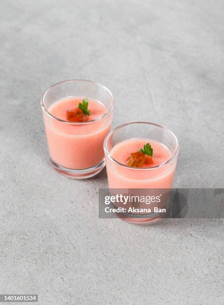 italian dessert. tomato panna cotta in a glass.  light grey background - panna cotta stock pictures, royalty-free photos & images