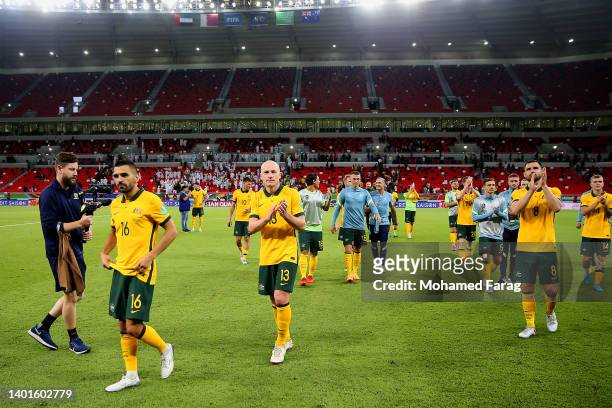 Aziz Behich and Aaron Mooy of Australia celebrate after their sides victory during the 2022 FIFA World Cup Playoff match between United Arab Emirates...