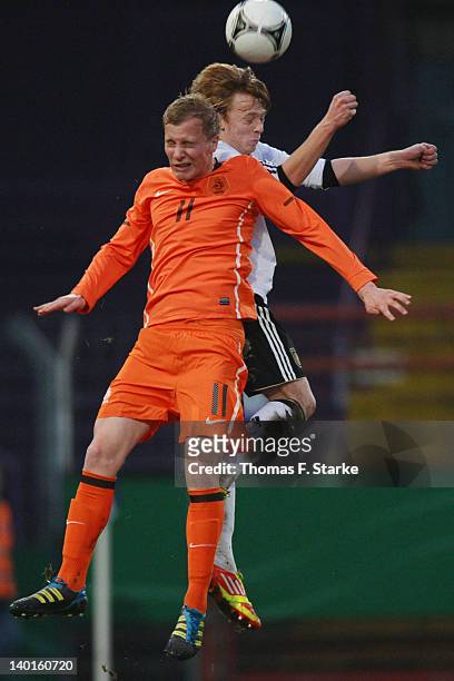 Nick De Bondt of Netherlands and Marcel Deelen of Germany head for the ball during the U18 international friendly match between Germany and...