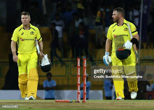 Australian batsmen Aaron Finch and David Warner leave the ground after winning the match during the 1st match in the T20 International series between...