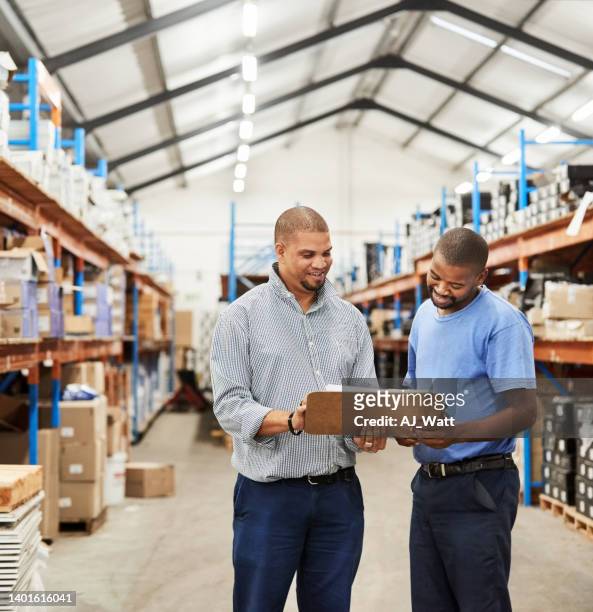 two male warehouse coworkers discussing over inventory - delivery character stock pictures, royalty-free photos & images