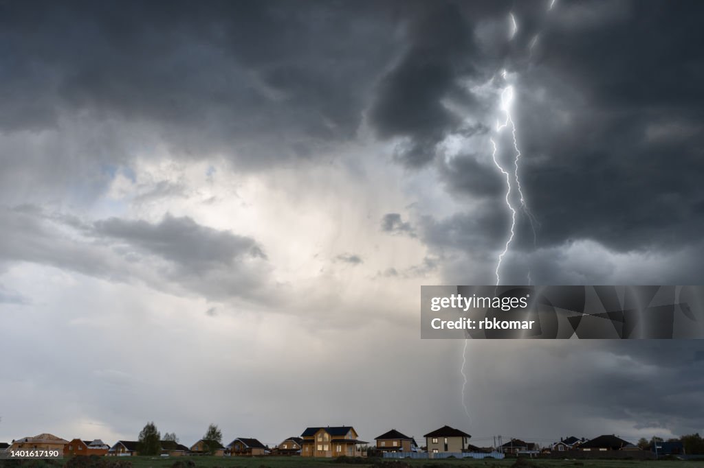 Cloud storm sky with thunderbolt over the village in rural scene