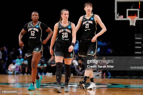Forward Michaela Onyenwere, guard Sabrina Ionescu, and center Han Xu of the New York Liberty look on during the first half against the Minnesota Lynx...