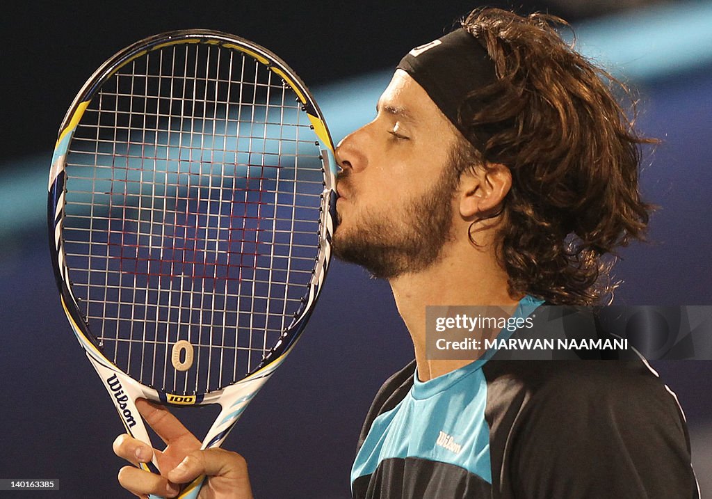 Feliciano Lopez of Spain kisses his rack