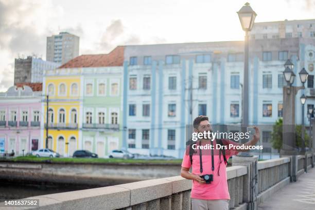 tourist taking selfie in recife city - travel real people stockfoto's en -beelden