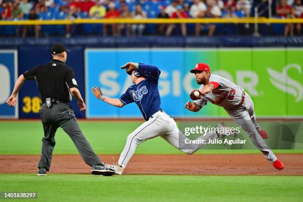 Edmundo Sosa of the St. Louis Cardinals runs down Brett Phillips of the Tampa Bay Rays in the second inning at Tropicana Field on June 07, 2022 in St...