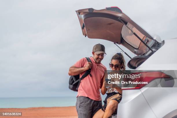 couple looking at photos they just took - car instagram stock pictures, royalty-free photos & images