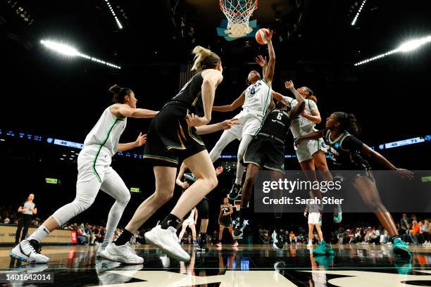 Kamiah Smalls of the Minnesota Lynx goes to the basket as forward Natasha Howard of the New York Liberty defends during the game at Barclays Center...